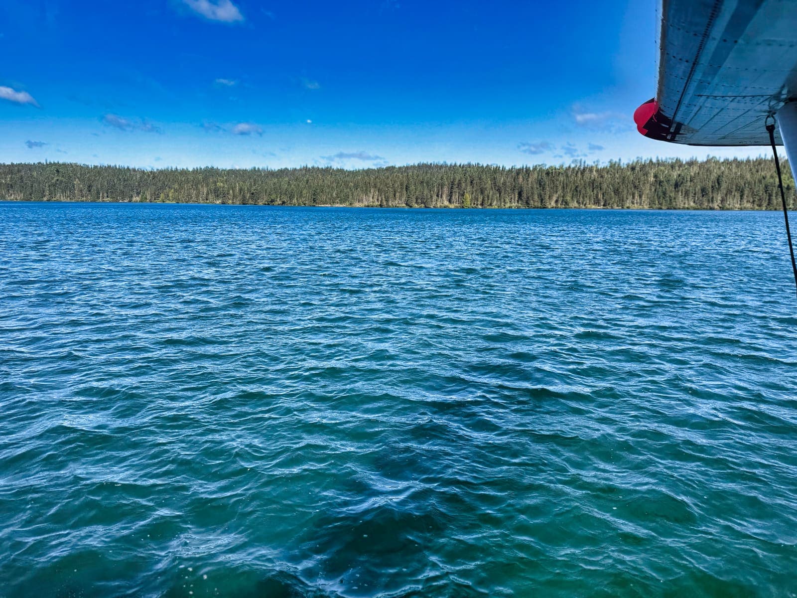 The wing of a floatplane over open water at Isle Royale