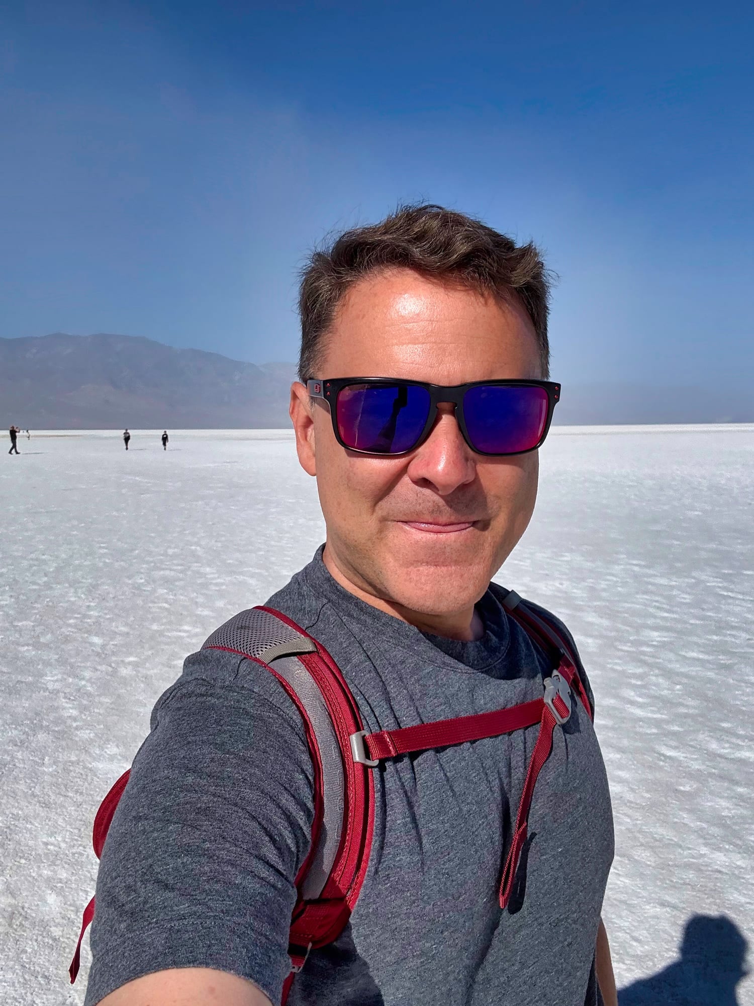 Ryan on the Badwater salt flats in Death Valley, sun-bright and wide open
